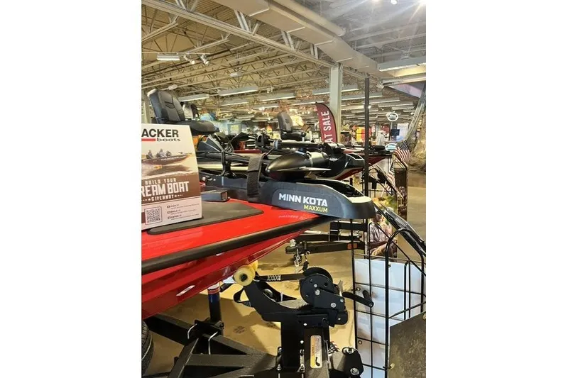 Slide: The Image of 2026 Tracker Pro Team 195 boat displayed in a showroom with Minn Kota Maxxum motor. - 8