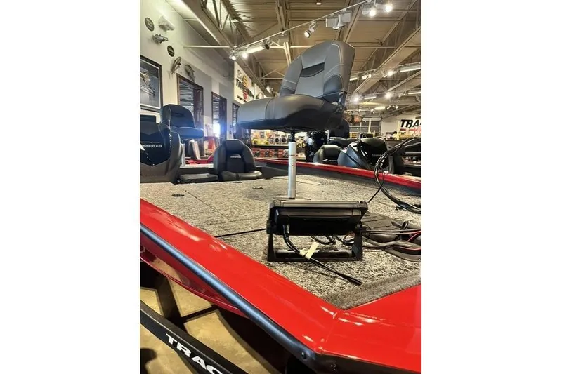 Slide: The Image of 2026 Tracker Pro Team 195 boat interior with seating and equipment in showroom. - 7