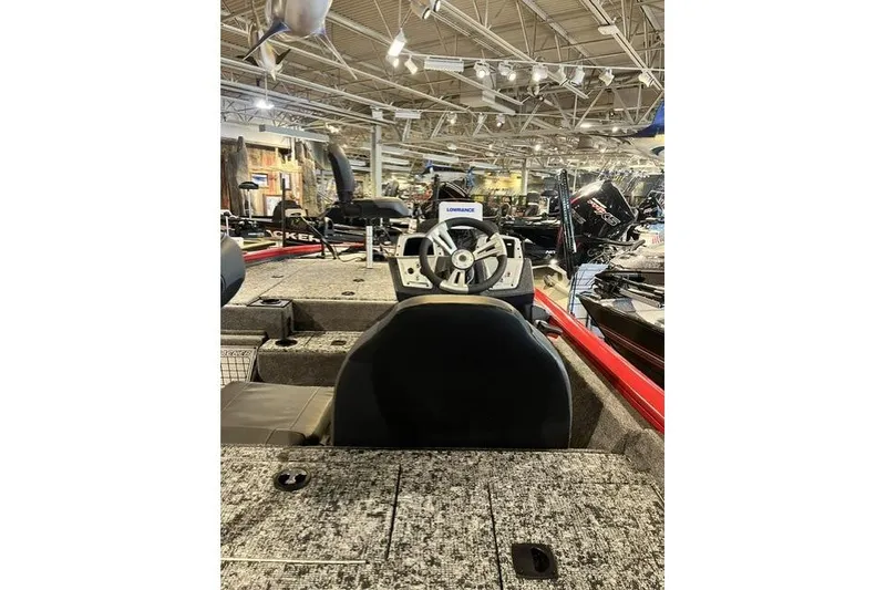 Slide: The Image of 2026 Tracker Pro Team 195 boat interior with steering wheel in showroom. - 61