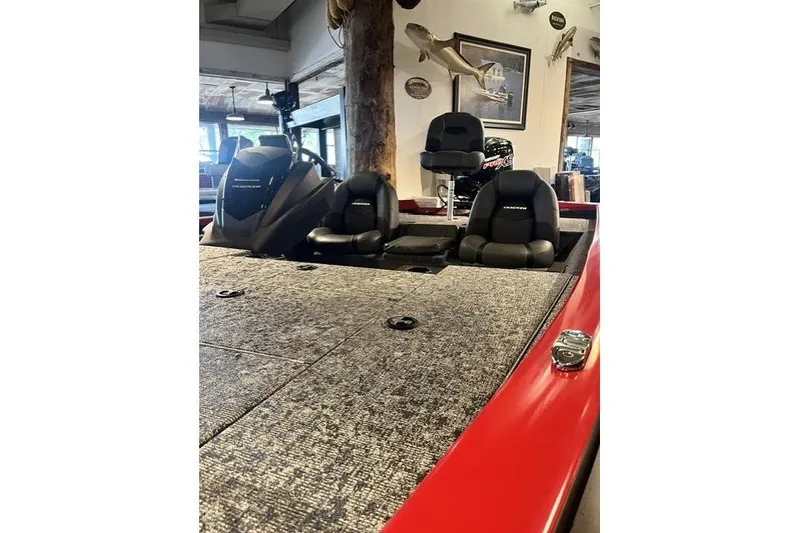 Slide: The Image of 2026 Tracker Pro Team 195 boat interior with seating and motor, displayed indoors. - 3
