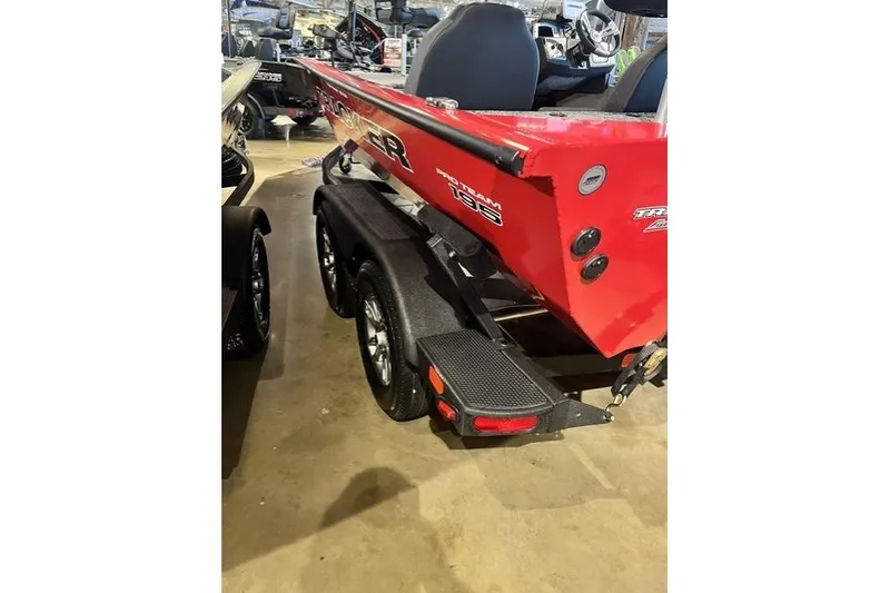 Slide: The Image of Red 2026 Tracker Pro Team 195 boat on trailer, displayed indoors. - 63