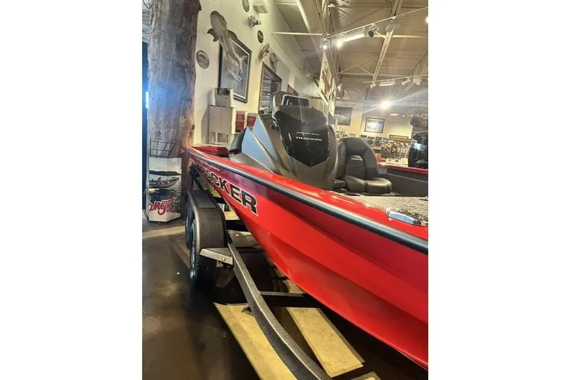 Slide: The Image of Red 2026 Tracker Pro Team 195 boat displayed indoors, showcasing sleek design and seating. - 6