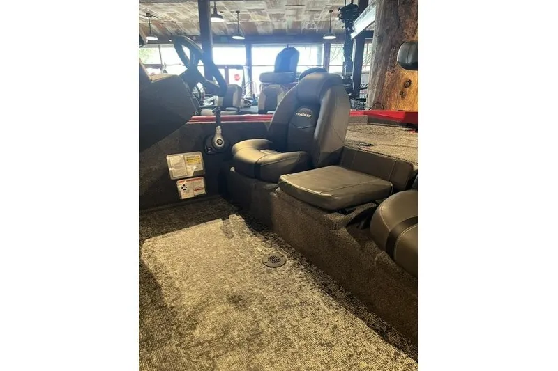 Slide: The Image of 2026 Tracker Pro Team 195 boat interior with black seating and steering wheel. - 4