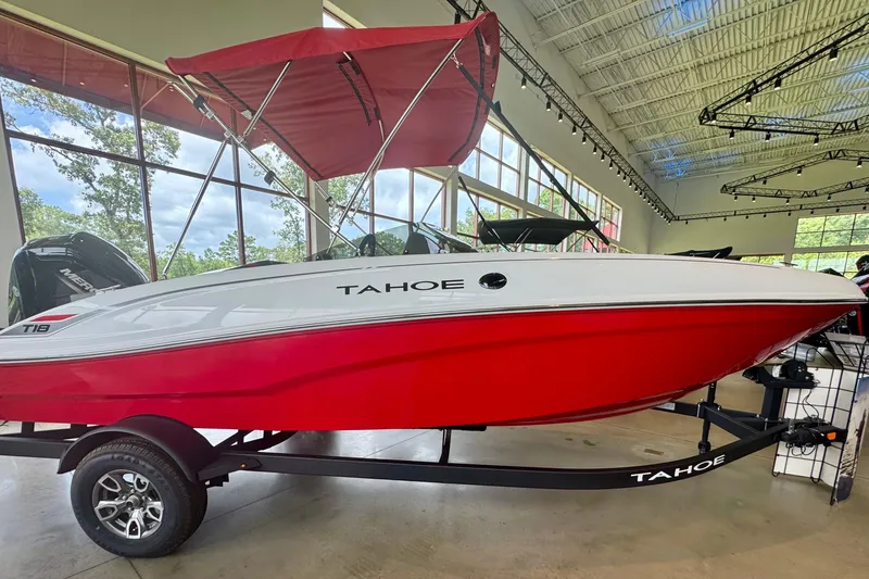 The Image of 2026 Tahoe T18 boat with red hull and canopy displayed indoors. - 0
