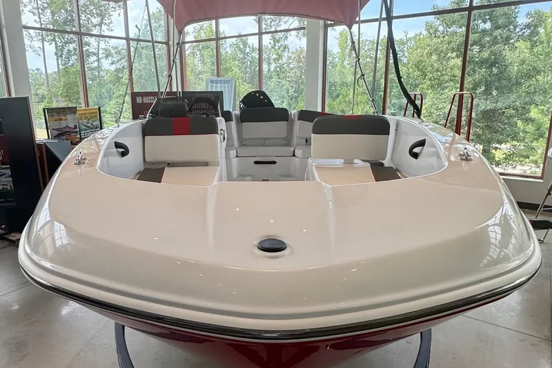 Slide: The Image of 2026 Tahoe T18 boat displayed indoors with seating and canopy. - 1