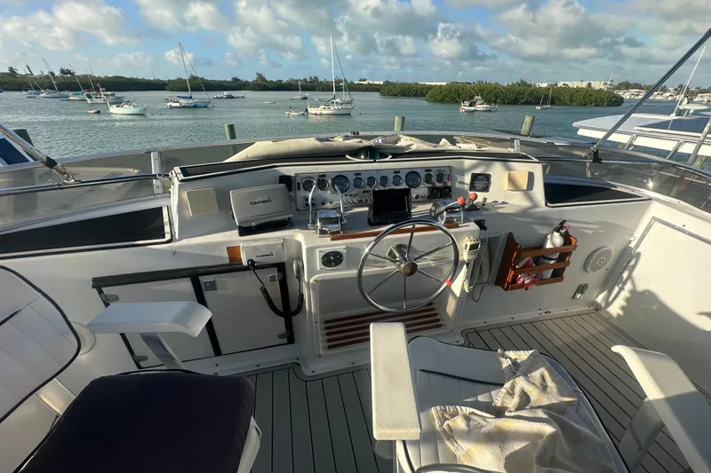 Slide: The Image of 1988 Chris Craft 46 Constellation yacht cockpit with steering wheel and navigation equipment. - 12