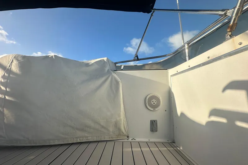 Slide: The Image of 1988 Chris Craft 46 Constellation deck with covered seating and clear blue sky. - 19