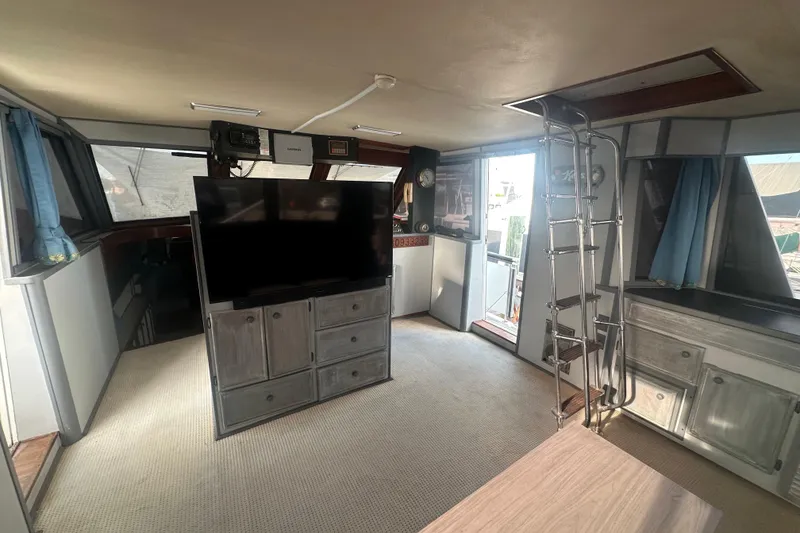 Slide: The Image of Interior of 1988 Chris Craft 46 Constellation yacht with modern amenities and ladder access. - 23