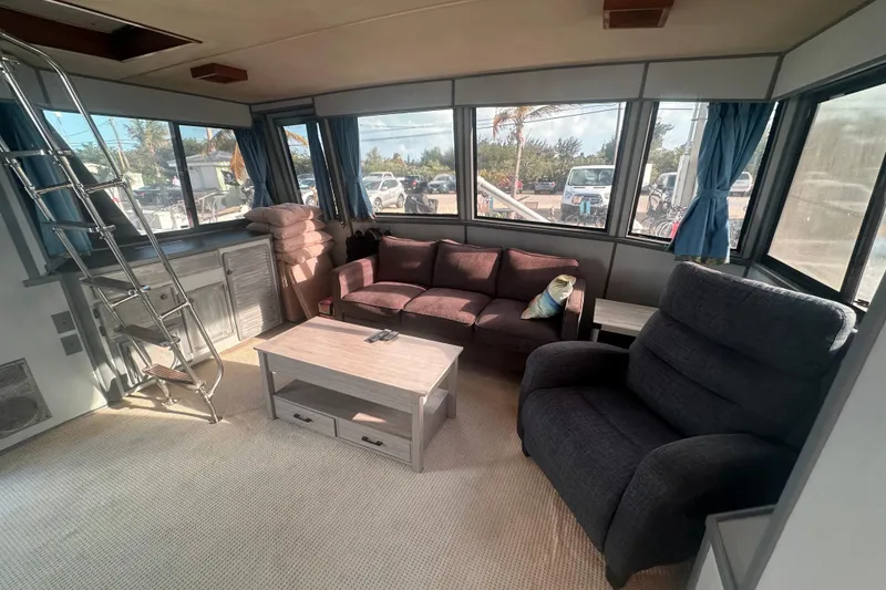 Slide: The Image of Interior of 1988 Chris Craft 46 Constellation yacht with cozy seating and large windows. - 24