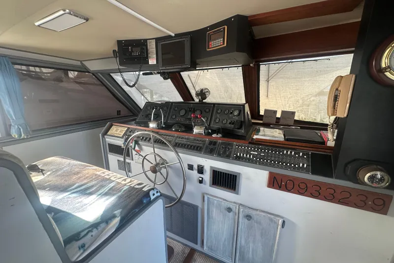 Slide: The Image of 1988 Chris Craft 46 Constellation helm with vintage controls and steering wheel. - 25