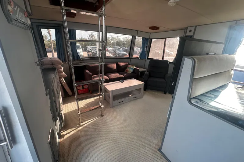 Slide: The Image of Interior of 1988 Chris Craft 46 Constellation yacht with cozy seating and ladder. - 26