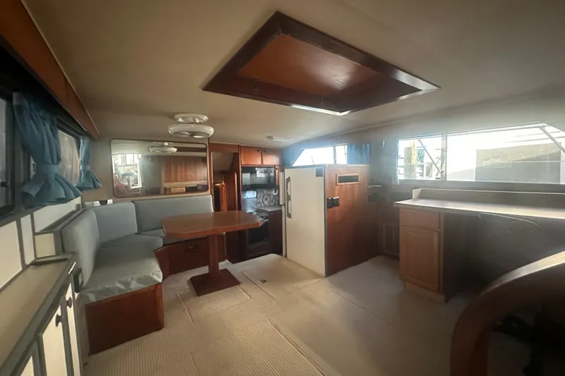 Slide: The Image of Interior of 1988 Chris Craft 46 Constellation yacht with dining area and kitchen. - 27