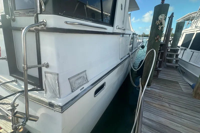 Slide: The Image of 1988 Chris Craft 46 Constellation yacht docked at marina, side view. - 3