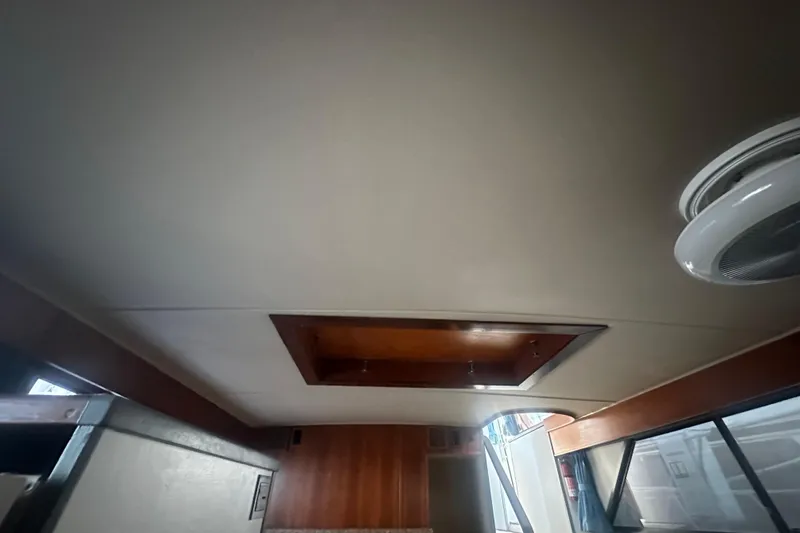 Slide: The Image of Interior ceiling view of 1988 Chris Craft 46 Constellation yacht with wooden accents. - 30