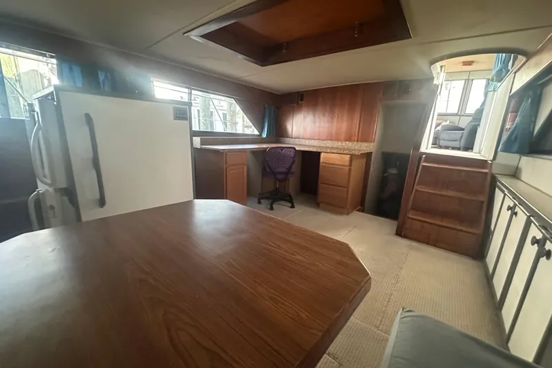 Slide: The Image of Interior of 1988 Chris Craft 46 Constellation yacht with wood furnishings and seating area. - 32