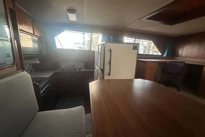 Slide: The Image of Interior of 1988 Chris Craft 46 Constellation yacht with kitchen and dining area. - 33