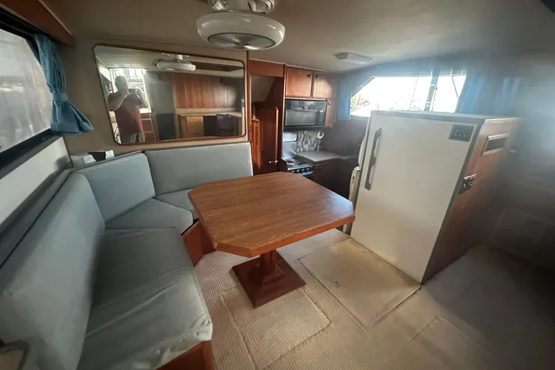 Slide: The Image of 1988 Chris Craft 46 Constellation yacht interior with dining area and kitchen. - 36