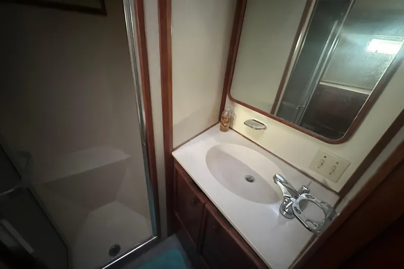 Slide: The Image of 1988 Chris Craft 46 Constellation bathroom with sink, mirror, and shower. - 38