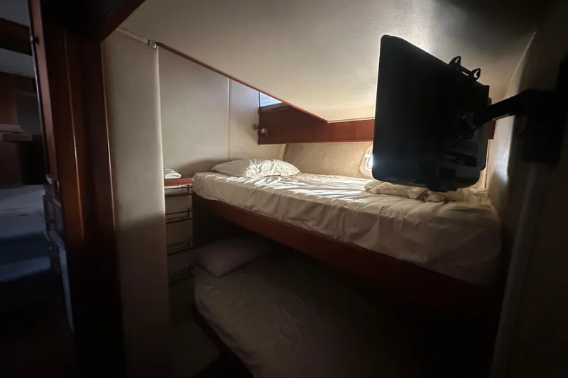 Slide: The Image of 1988 Chris Craft 46 Constellation cabin interior with bunk beds and mounted TV. - 40