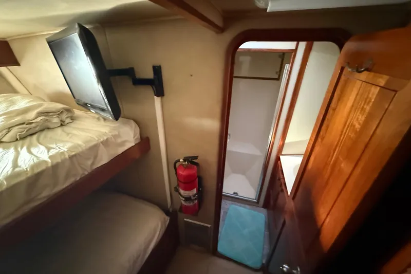 Slide: The Image of Interior of 1988 Chris-Craft 46 Constellation with bunk beds, TV, and bathroom. - 42