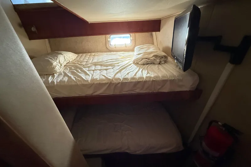 Slide: The Image of Cozy cabin interior of 1988 Chris-Craft 46 Constellation with bunk beds and TV. - 43
