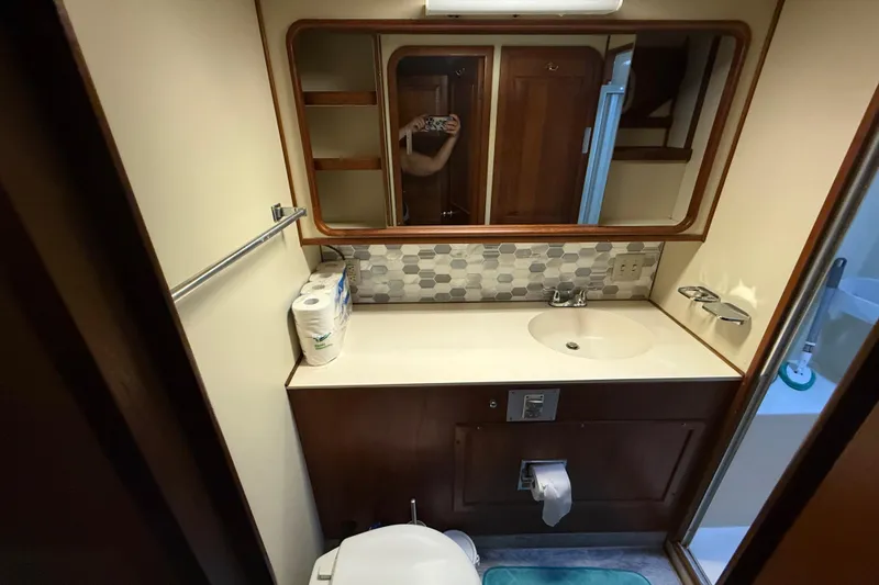 Slide: The Image of Bathroom interior of 1988 Chris-Craft 46 Constellation yacht, featuring sink and toilet. - 46
