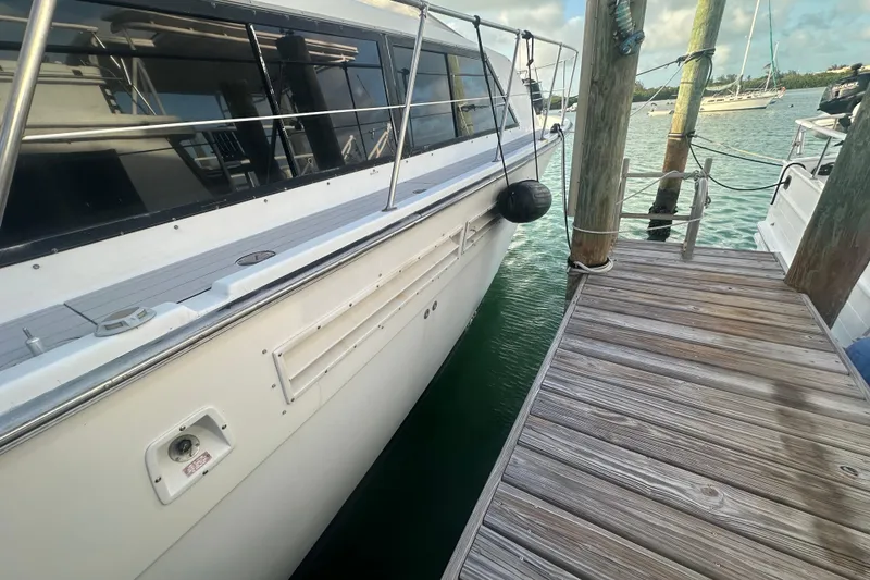 Slide: The Image of 1988 Chris Craft 46 Constellation yacht docked beside wooden pier. - 6