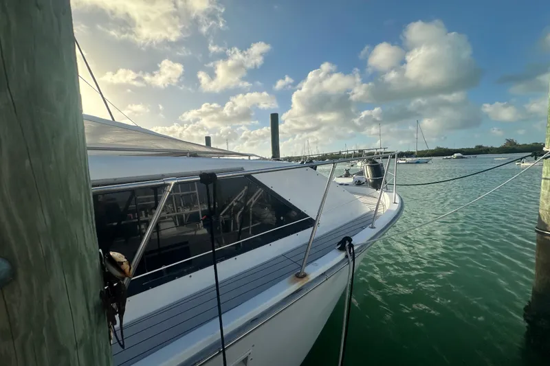 Slide: The Image of 1988 Chris Craft 46 Constellation yacht docked in a serene marina setting. - 9