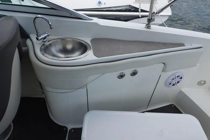 Slide: The Image of 2011 Sea Ray 260 Sundeck interior with sink and seating area. - 11