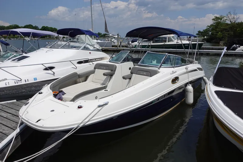 Slide: The Image of 2011 Sea Ray 260 Sundeck boat docked at marina, featuring sleek design and spacious seating. - 2