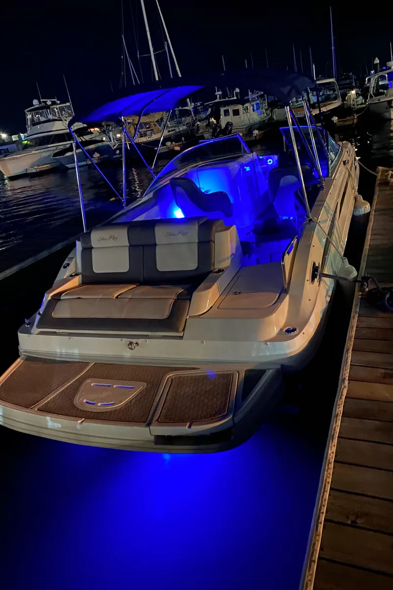 Slide: The Image of 2011 Sea Ray 260 Sundeck with blue LED lights docked at night. - 4
