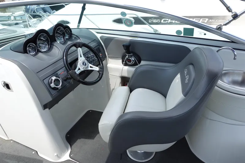 Slide: The Image of 2011 Sea Ray 260 Sundeck cockpit with steering wheel and gauges. - 6
