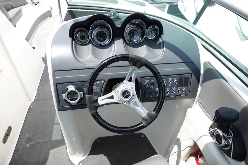 Slide: The Image of 2011 Sea Ray 260 Sundeck dashboard with steering wheel and instrument panel. - 7
