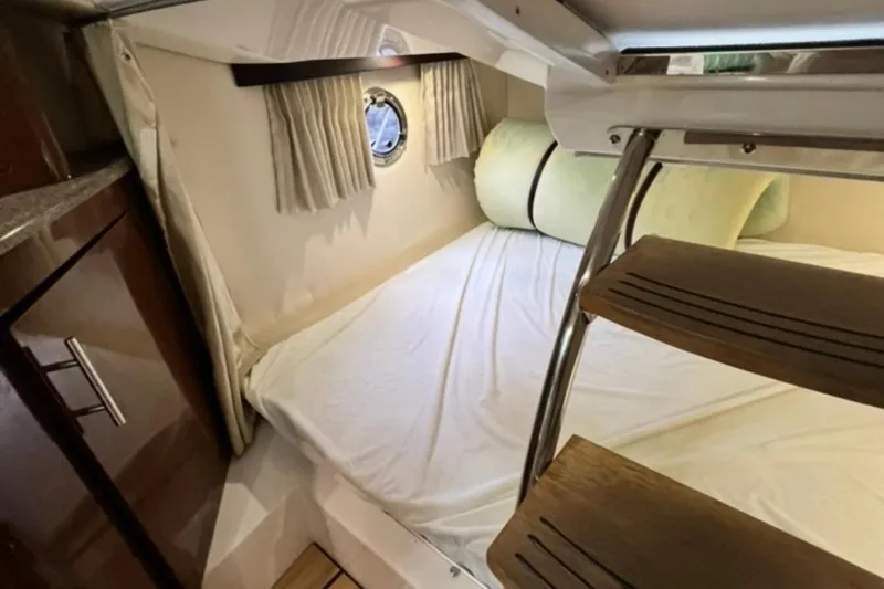Slide: The Image of Cozy cabin interior of 2015 Regal 28 Express boat with bed and porthole. - 10