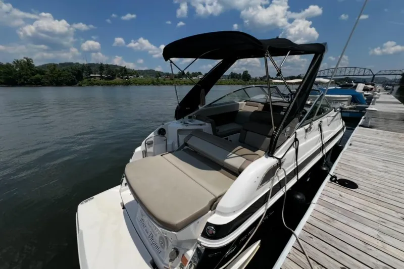 Slide: The Image of 2015 Regal 28 Express boat docked by a scenic river under a blue sky. - 5