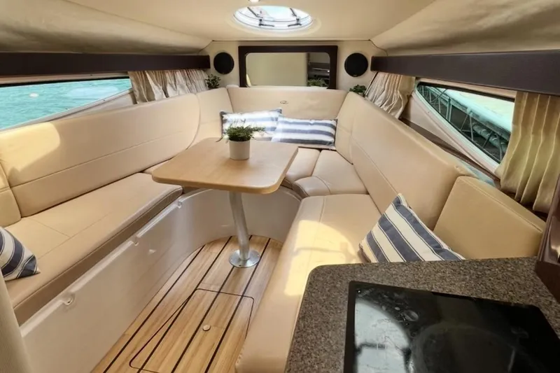 Slide: The Image of Interior of 2015 Regal 28 Express boat with cozy seating and table. - 8