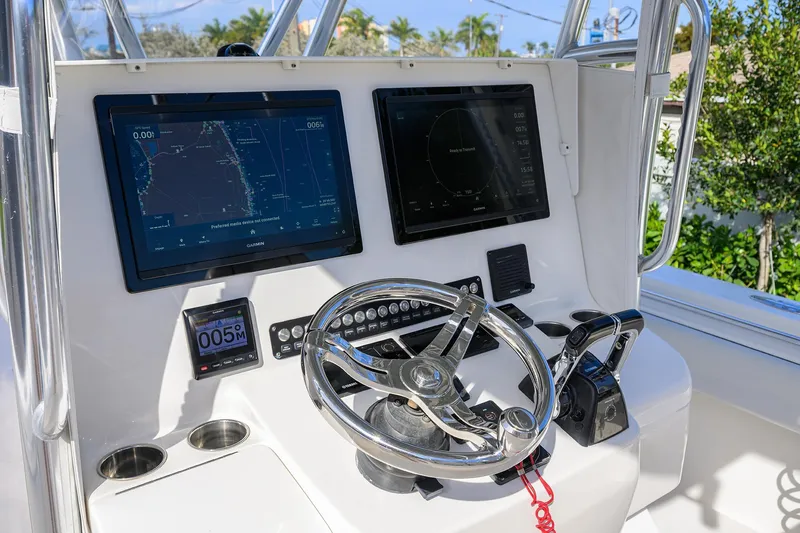 Slide: The Image of 2019 Contender 35 ST boat dashboard with dual Garmin displays and steering wheel. - 10