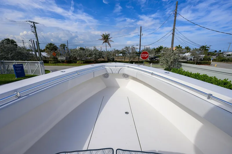 Slide: The Image of 2019 Contender 35 ST boat bow view with clear sky and street background. - 13