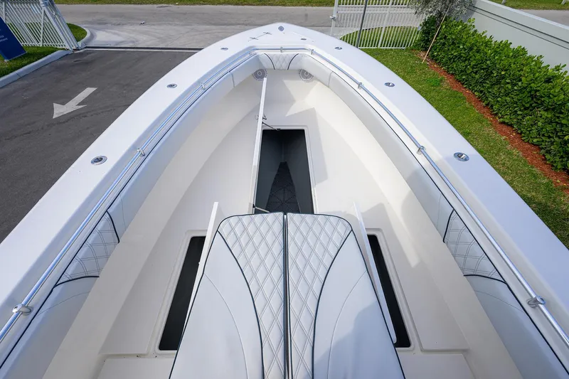 Slide: The Image of 2019 Contender 35 ST boat interior with white seating and storage compartments. - 14