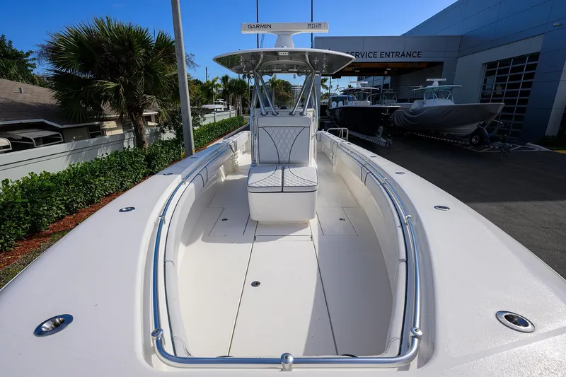 Slide: The Image of 2019 Contender 35 ST boat at service entrance, featuring sleek design and spacious deck. - 15