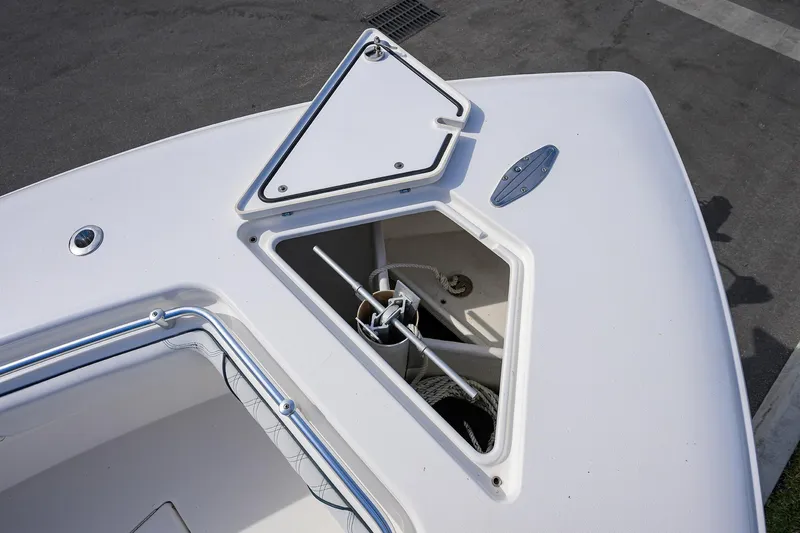 Slide: The Image of 2019 Contender 35 ST boat anchor compartment with open hatch, showcasing storage space. - 18