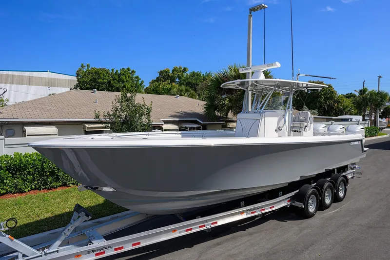 Slide: The Image of 2019 Contender 35 ST boat on trailer, parked outdoors under clear blue sky. - 2