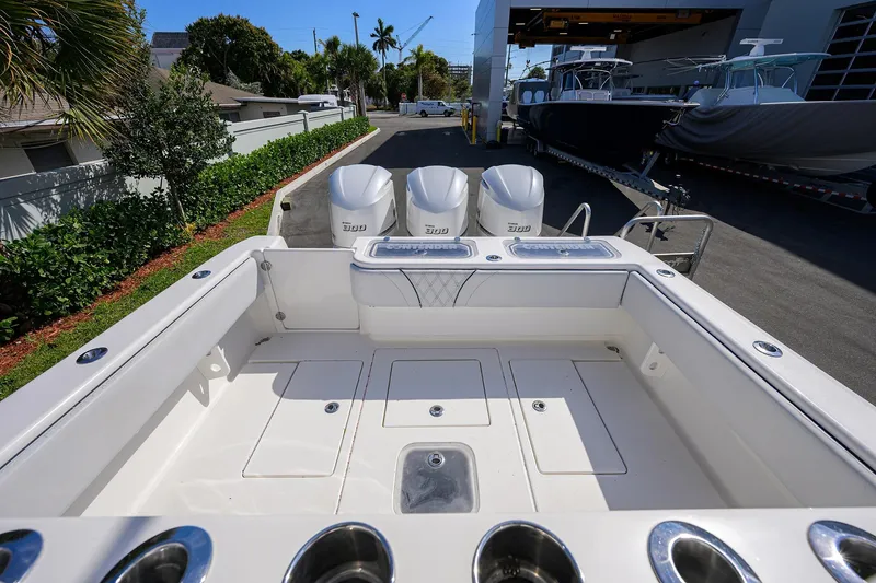 Slide: The Image of 2019 Contender 35 ST boat with triple engines, docked outdoors. - 23