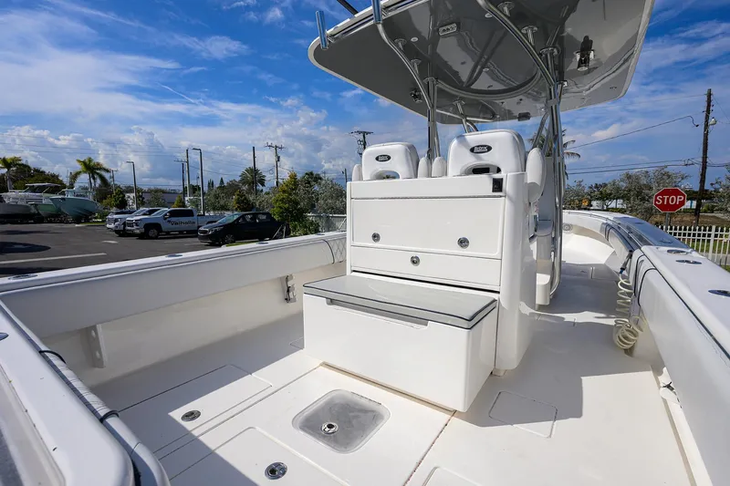 Slide: The Image of 2019 Contender 35 ST boat interior with seating and storage, under a clear blue sky. - 29