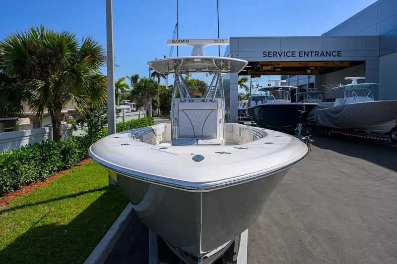 Slide: The Image of 2019 Contender 35 ST boat at service entrance, surrounded by palm trees and other boats. - 3