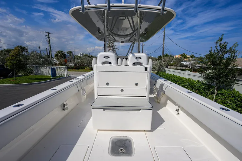 Slide: The Image of 2019 Contender 35 ST boat interior with seating and storage, under a clear blue sky. - 30