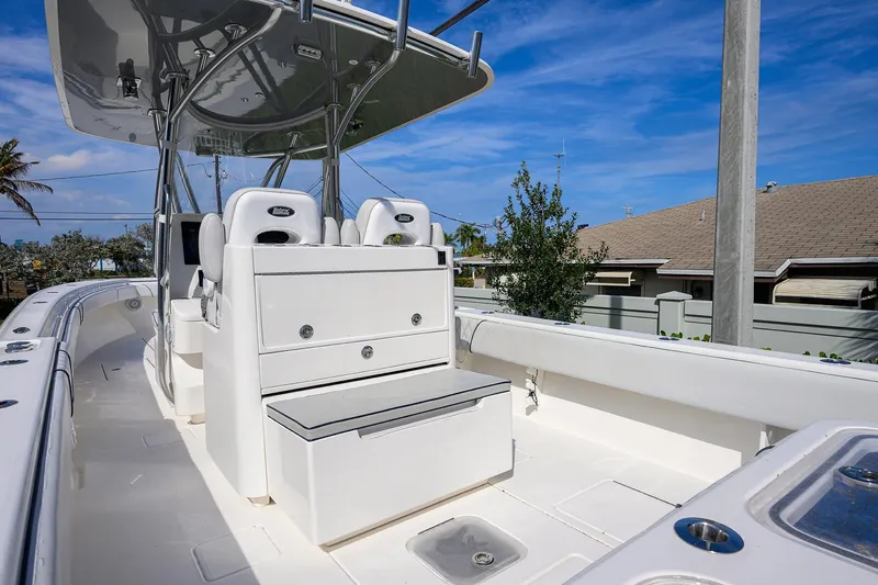Slide: The Image of 2019 Contender 35 ST boat interior with seating and console under blue sky. - 32