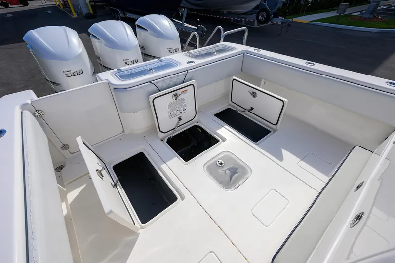 Slide: The Image of 2019 Contender 35 ST boat deck with open storage compartments and Yamaha engines. - 34