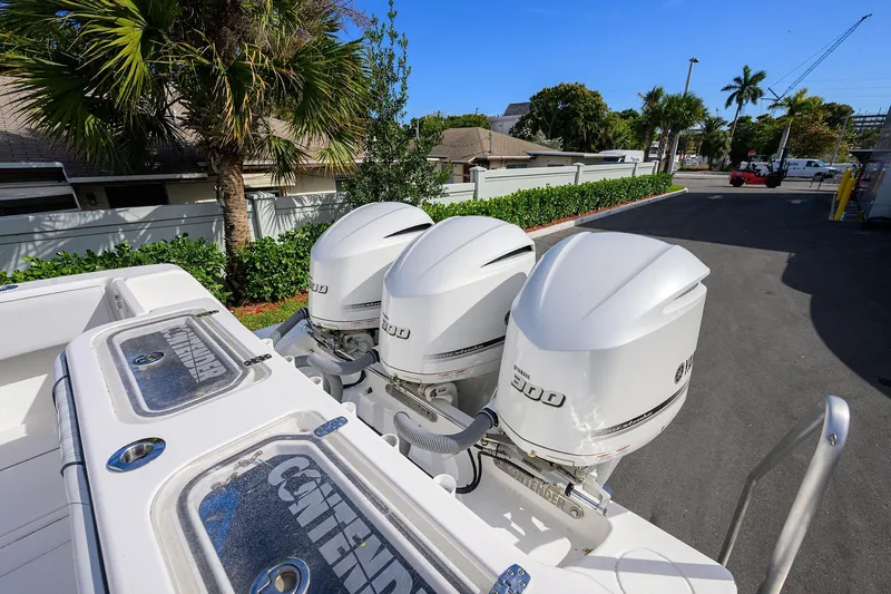 Slide: The Image of 2019 Contender 35 ST boat with triple Yamaha 300 engines, parked outdoors. - 38