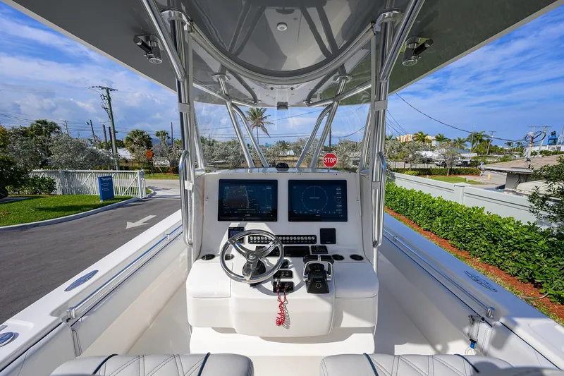 Slide: The Image of 2019 Contender 35 ST boat cockpit with modern navigation system and steering wheel. - 9